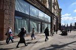 People walk past empty retail space on Tverskaya street in central Moscow, Russia.