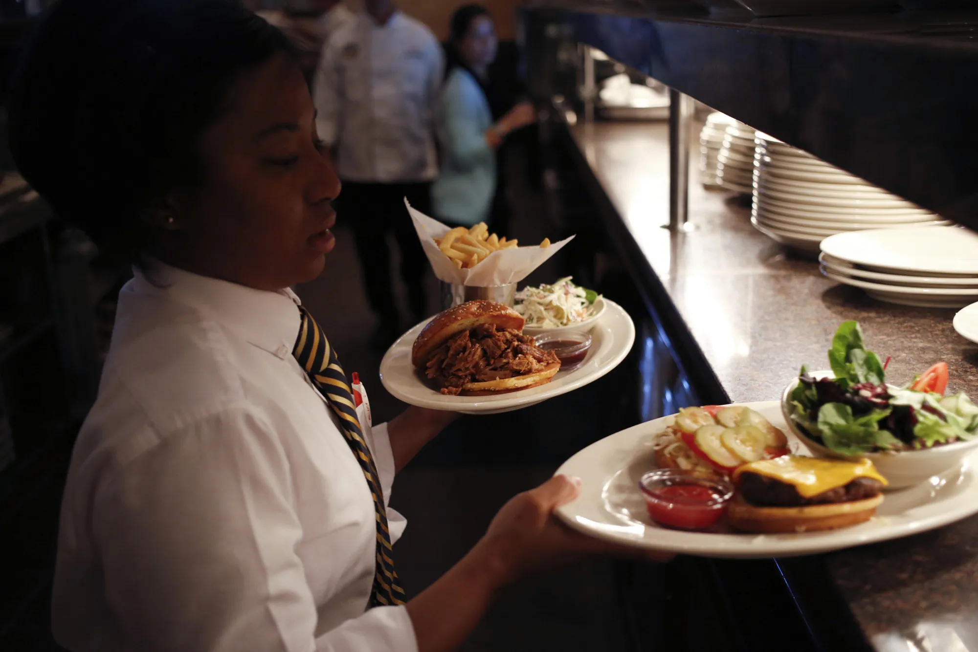 A server picks up an order for delivery to a table at a Cheesecake Factory Inc. restaurant in Louisville, Kentucky, U.S., on Wednesday, Nov. 13, 2013. Last month The Cheesecake Factory Inc. reported total revenues of $469.7 million in the third quarter of fiscal 2013 as compared to $453.8 million in the prior year third quarter.
