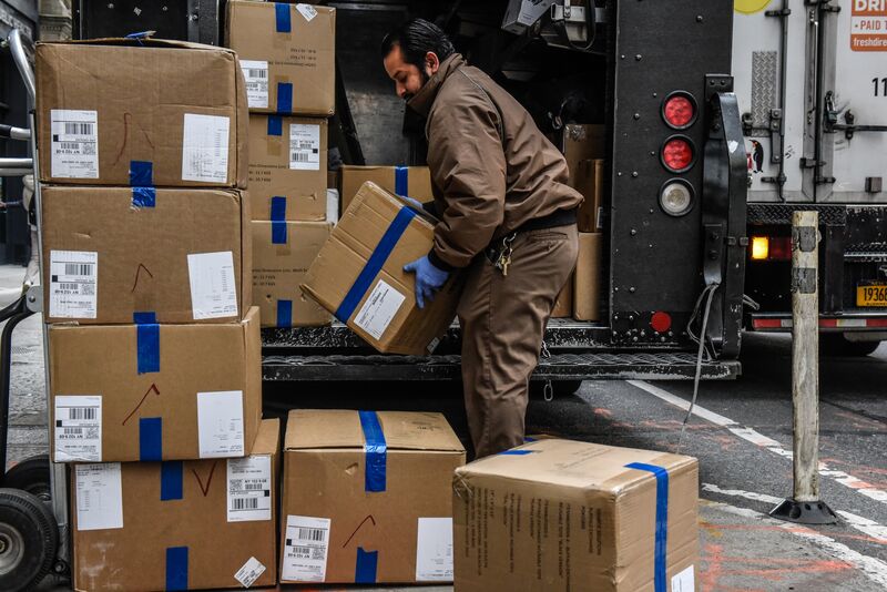 A UPS worker delivers packages on Cyber Monday in New York, Nov. 27, 2023.