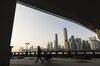 A worker pulls a cart under the Liede Bridge over the Pearl River in Guangzhou, China, on Wednesday, Nov. 1, 2017. China is poised for an acceleration of deals as confidence grows in the wake of last month’s Communist Party gathering and as the nation opens up to reforms.