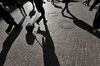 Shadows of workers in early morning hours on Wall Street near the New York Stock Exchange.