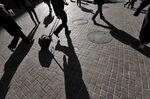 Shadows of workers in early morning hours on Wall Street near the New York Stock Exchange.