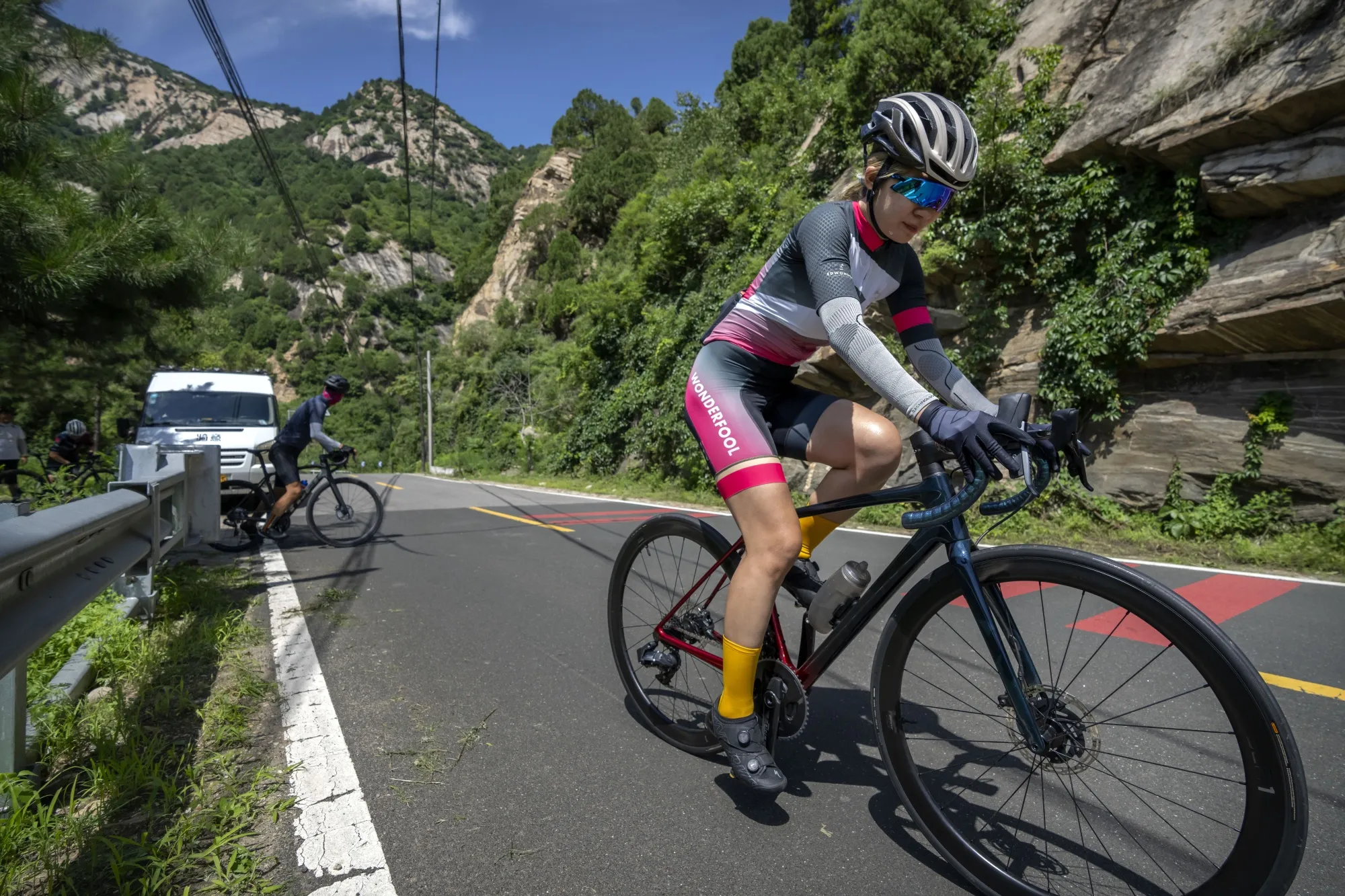 Members of the Qiyi bicycle club climb a hill on a rural road during a group ride through the Baihe River Canyon in the northern outskirts of Beijing, Wednesday, July 13, 2022. Cycling has gained increasing popularity in China as a sport. A coronavirus outbreak that shut down indoor sports facilities in Beijing earlier this year encouraged people to try outdoor sports including cycling, which was only a major tool of transport before 2000. (AP Photo/Mark Schiefelbein)
