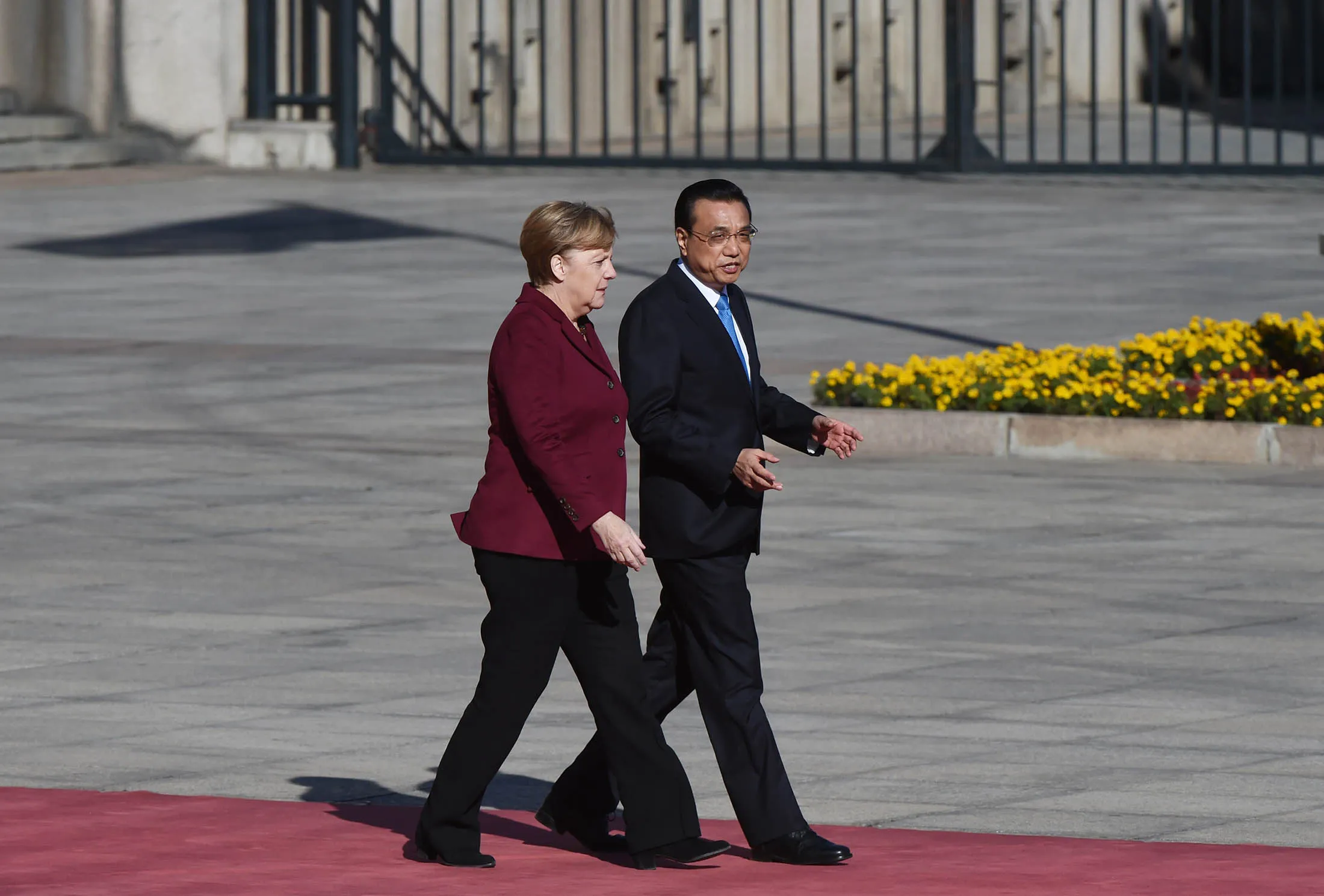 German Chancellor Angela Merkel chats with Chinese Premier Li Keqiang during a welcome ceremony outside the Great Hall of the People in Beijing on Oct. 29.
