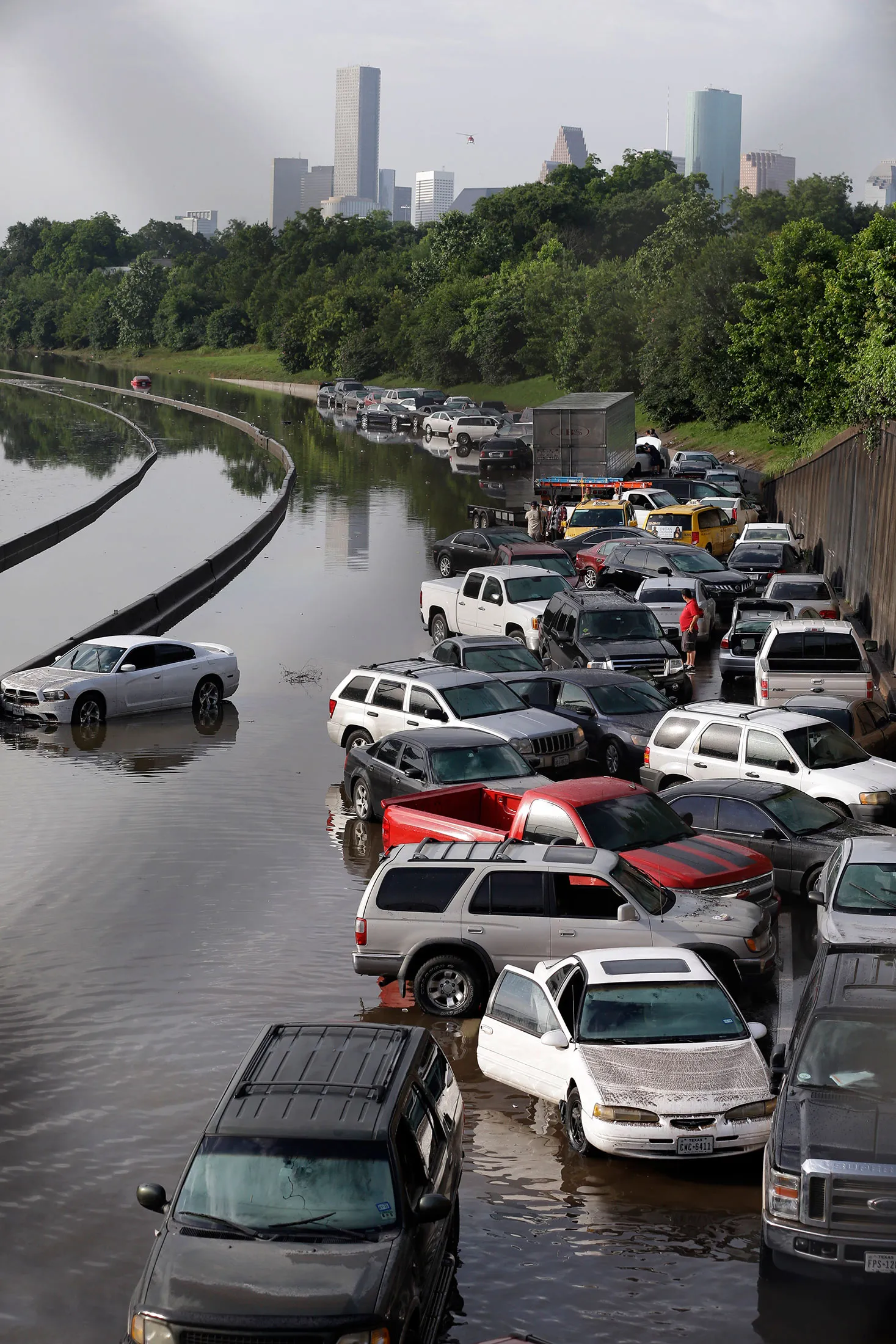 Cars remain stranded along a flooded section of Interstate 45 after heavy rains overnight in Houston, Tuesday, May 26, 2015. Several major highways are closed in the Houston area due to high water.
