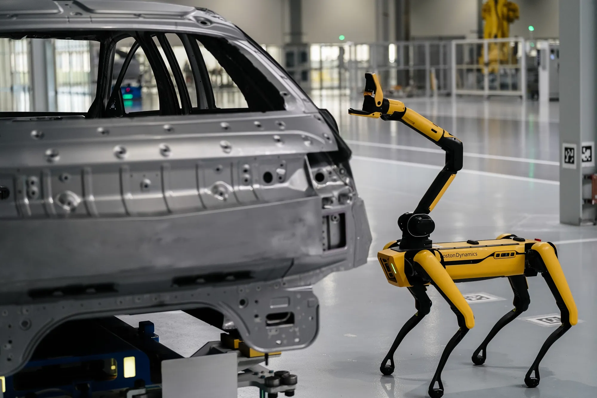 A Boston Dynamics Spot robot uses a camera to scan for defects on the body of a car at the Hyundai Metaplant electric vehicle manufacturing facility in Ellabell, Georgia.