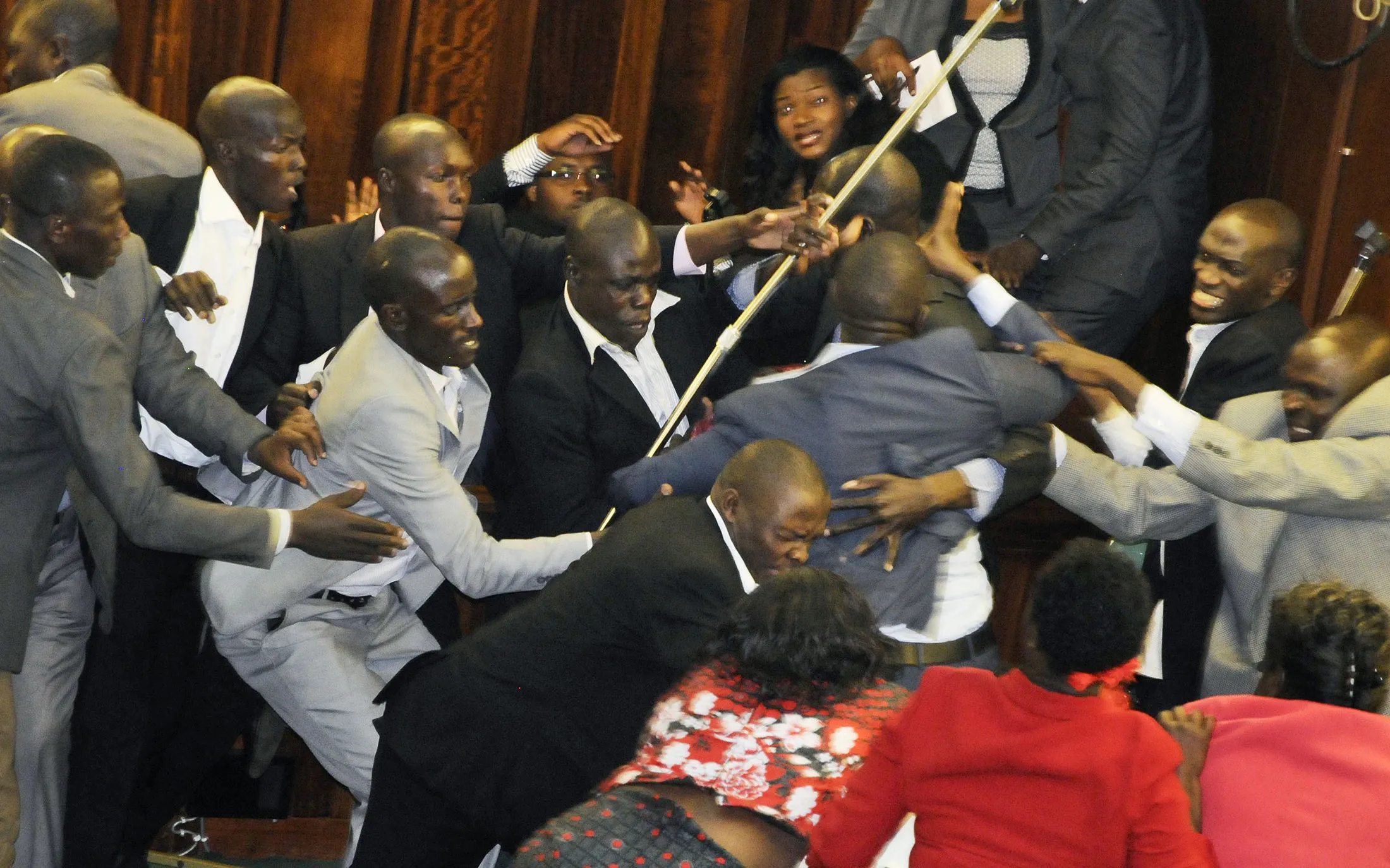 Ugandan opposition MPs scuffle with security trying to eject some of the MPs in the Parliament in Kampala, Uganda, on Sept. 27, 2017.
