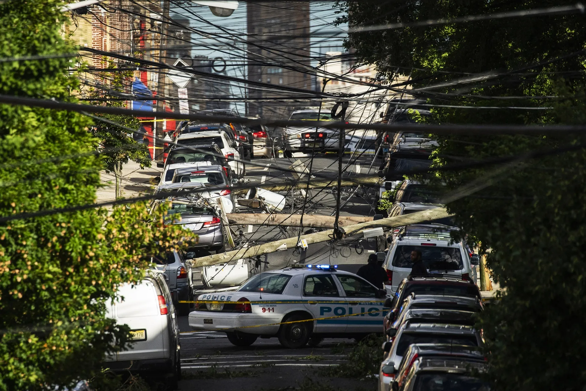 Power lines criss-cross at street level after Tropical Storm Isaias passed through Guttenberg, New Jersey.