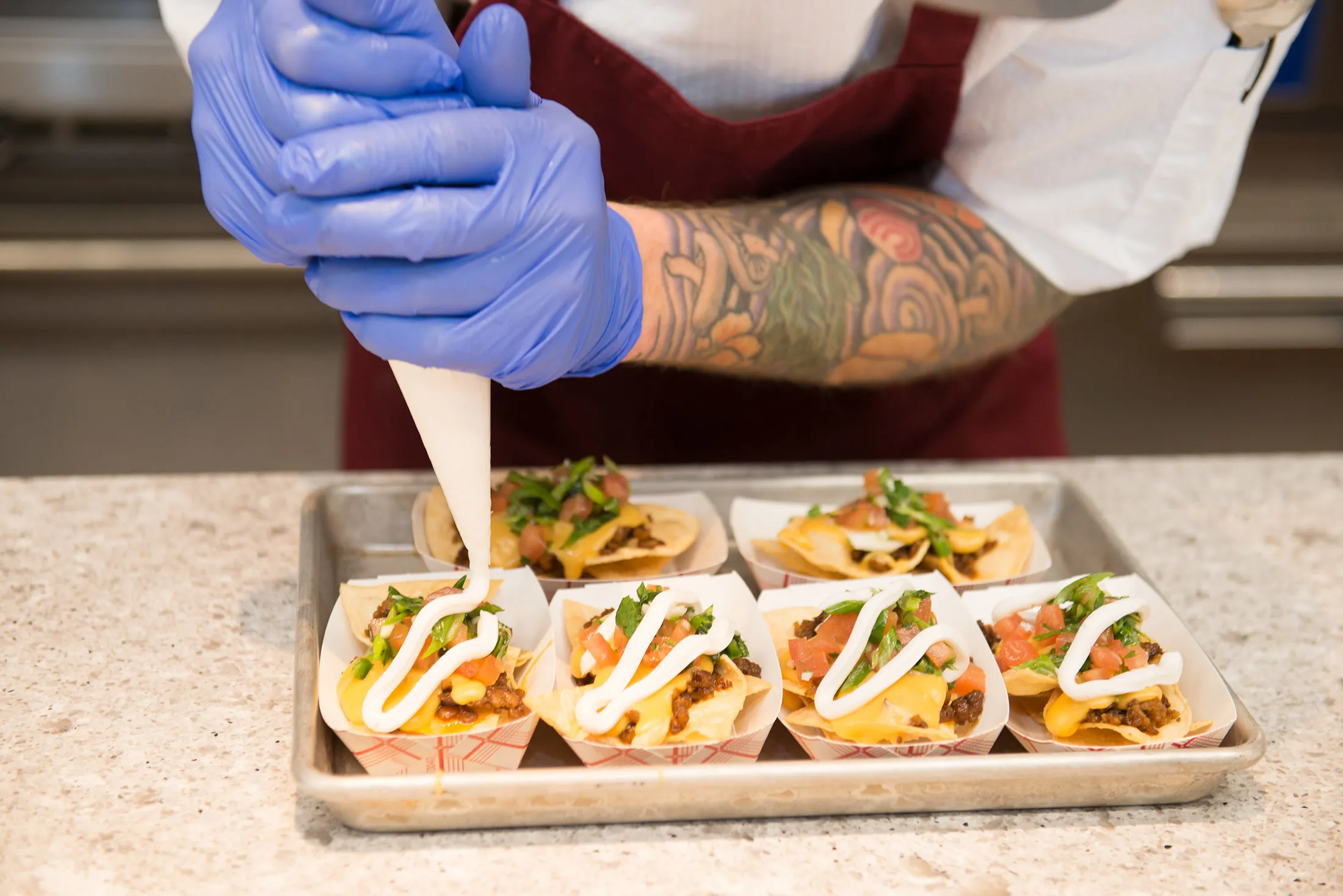A research chef prepares&nbsp;vegan nachos at a Bunge “innovation center.”