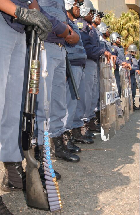 Heavily armed members of the South African public order police stand guard outside the conference centre at the start of the 2002 World Summit in Johannesburg. Monday August 26, 2002 Photographer : John Liebenberg/ Bloomberg