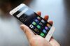 An attendee handles the Mi5 smartphone, manufactured by Xiaomi Corp., during its launch at the Mobile World Congress.
