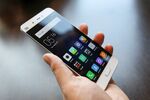 An attendee handles the Mi5 smartphone, manufactured by Xiaomi Corp., during its launch at the Mobile World Congress.