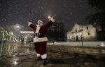 A man dressed as Santa Claus&nbsp;stands in front of the Alamo as snow falls in downtown San Antonio on&nbsp;Dec. 7, 2017.&nbsp;
