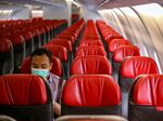 An official sits alone inside an aircraft before leaving Jakarta airport in Tangerang on February 1, 2020, in order to carry Indonesians back home from Wuhan, China.