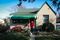 Kathy Kozachenko and her beagle/dachshund mix, Abby, in front of their yellow brick house in Pittsburgh’s Carrick neighborhood, on the southeastern edge of the city.
