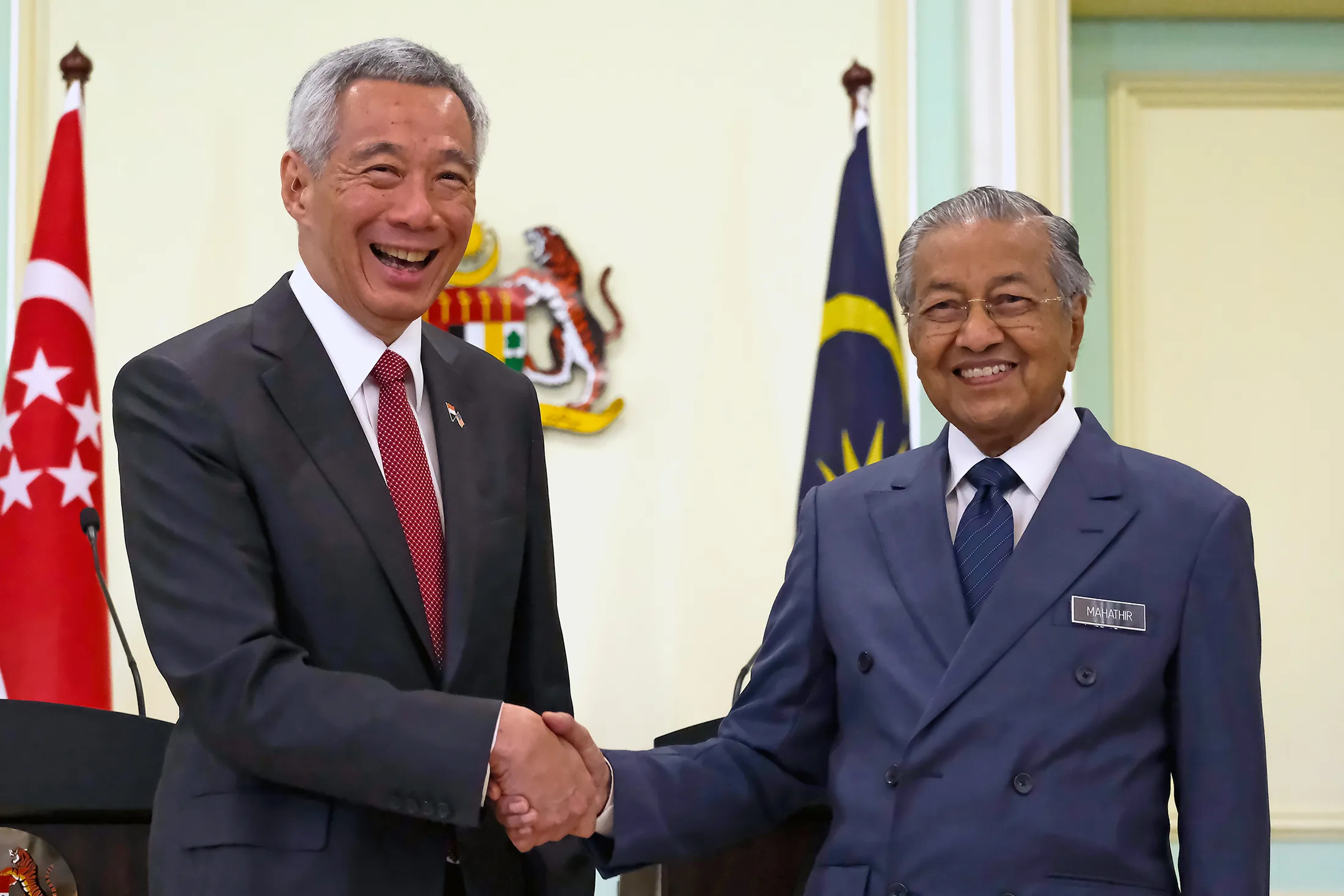 Lee Hsien Loong, left, shakes hand with Mahathir Mohamad in Putrajaya on April 9.