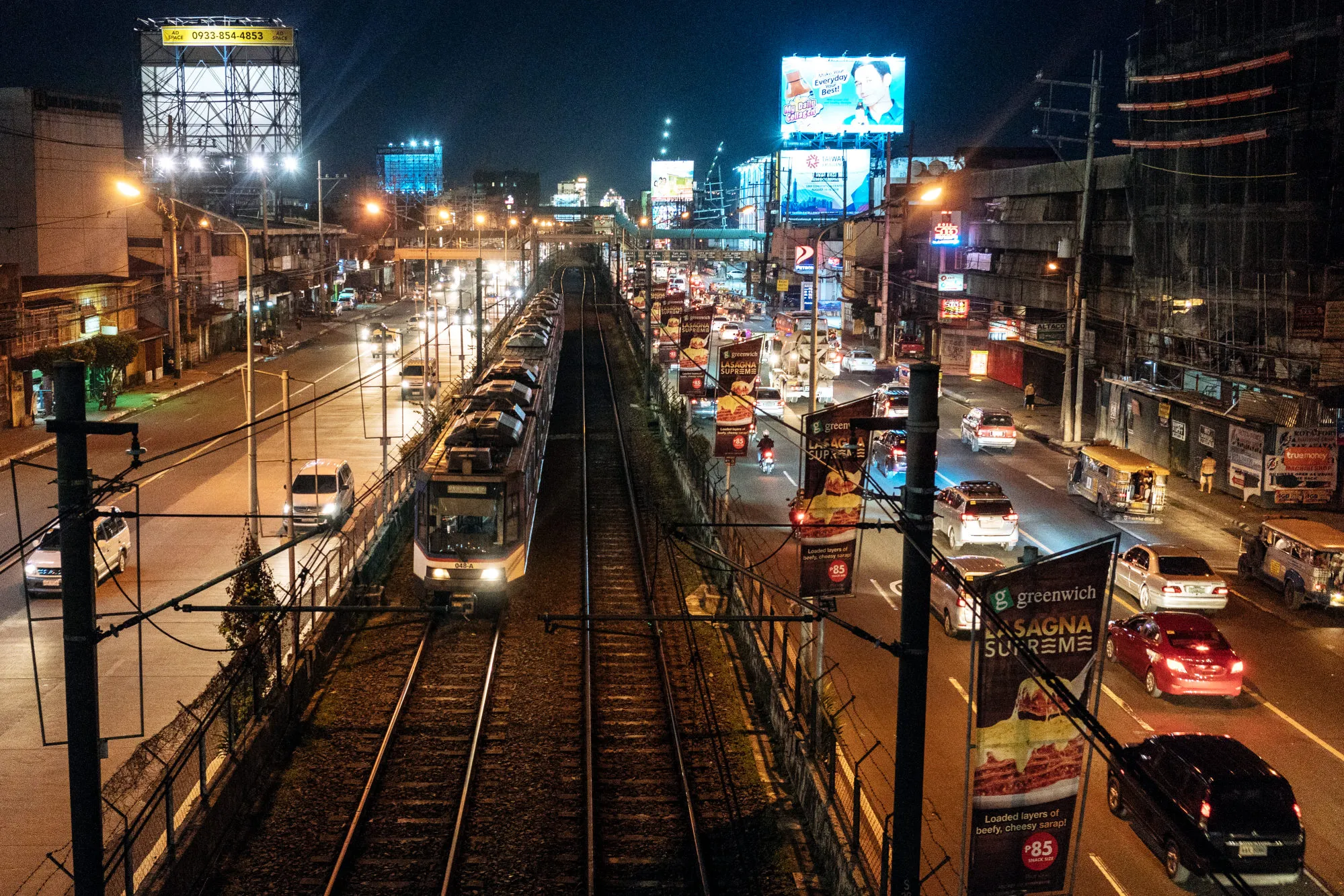 A train travels along an elevated rail track in Manila.