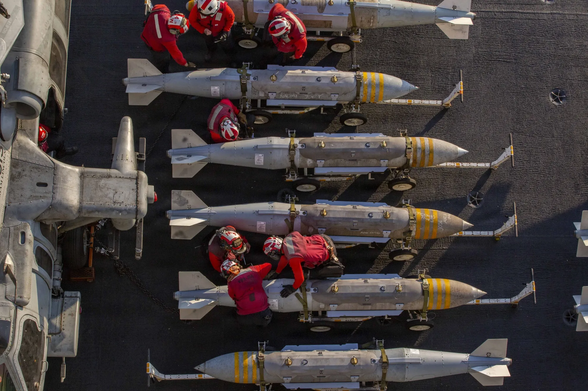 US sailors prepare ordnance on the flight deck of USS Abraham Lincoln, in a photo released by the US Navy, on Feb. 28.