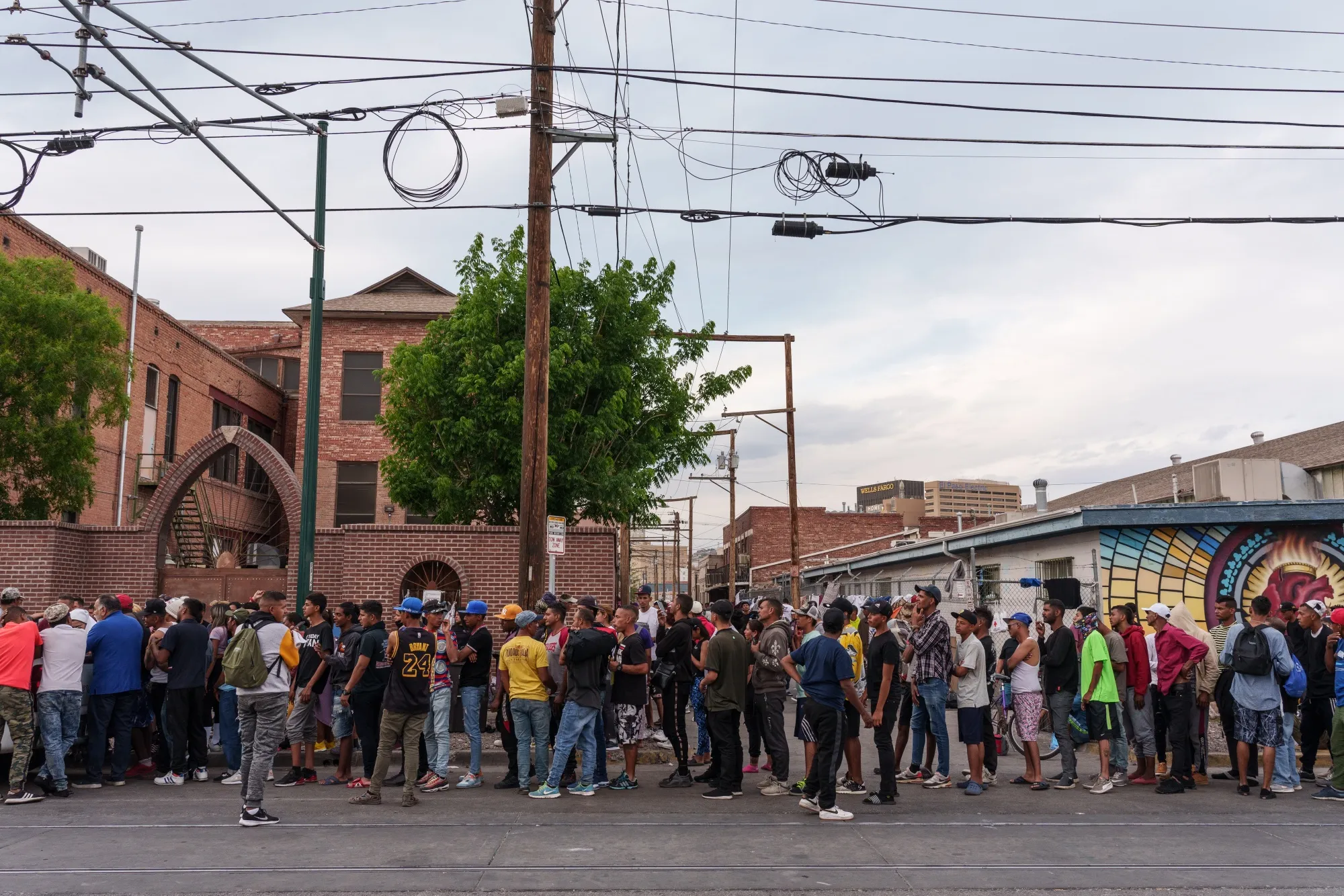 Migrants wait in line for donations outside of Sacred Heart Church before the lifting of Title 42 in El Paso, Texas, on May 3.
