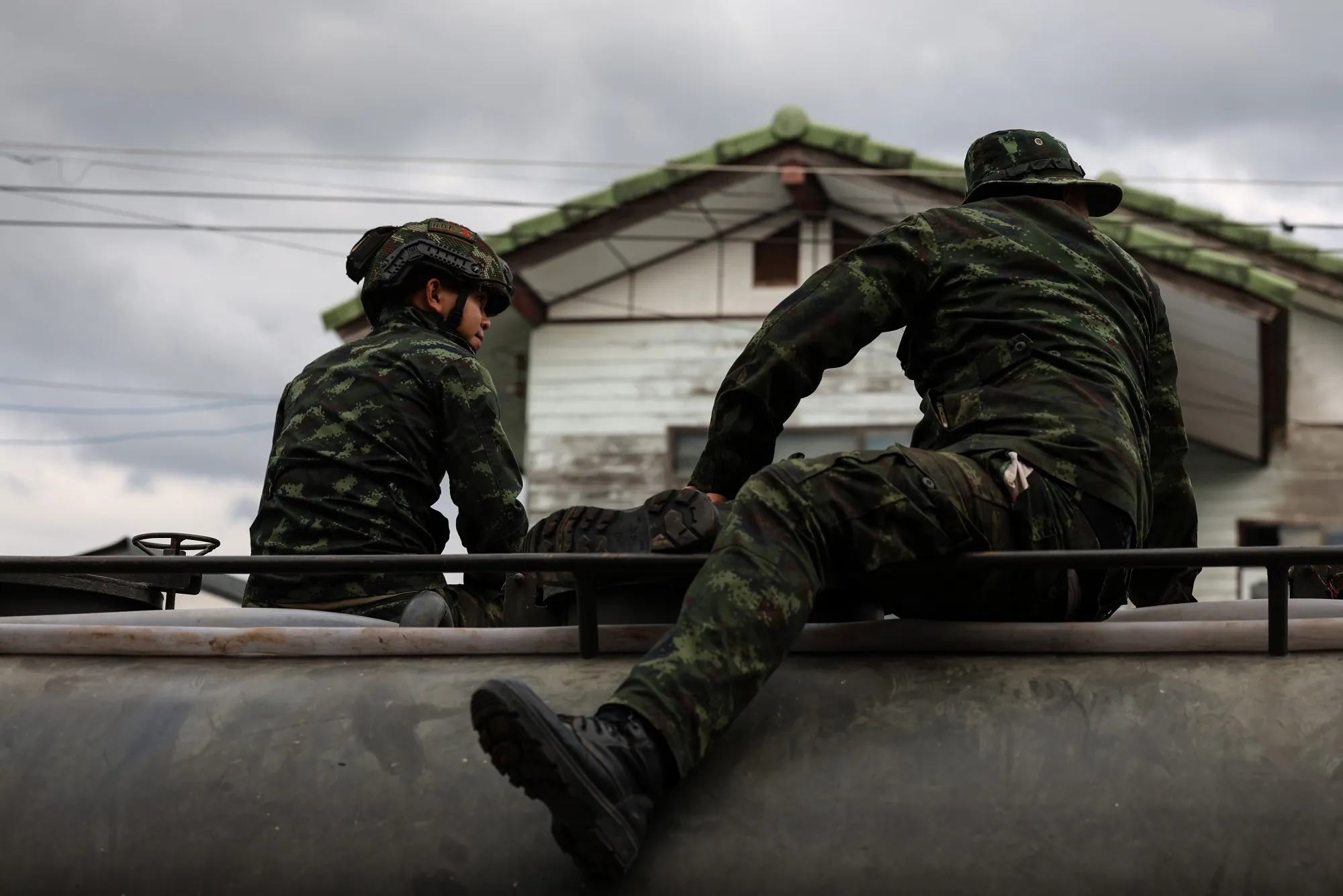 Thai military personnel sit on a military vehicle near the Thailand-Cambodia border.