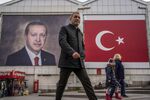 Pedestrians pass by a mural of Turkish President Recep Erdogan in Bursa, Turkey.