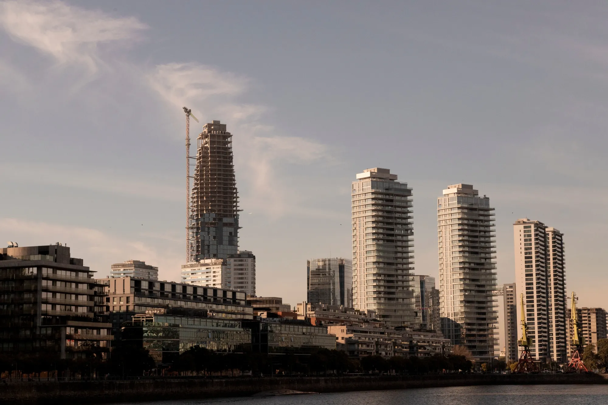 A tower under construction next to luxury residential buildings in the Puerto Madero neighborhood of Buenos Aires.