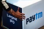 A worker prepares the stage during the listing ceremony for the IPO of One97 Communications Ltd., operator of PayTM