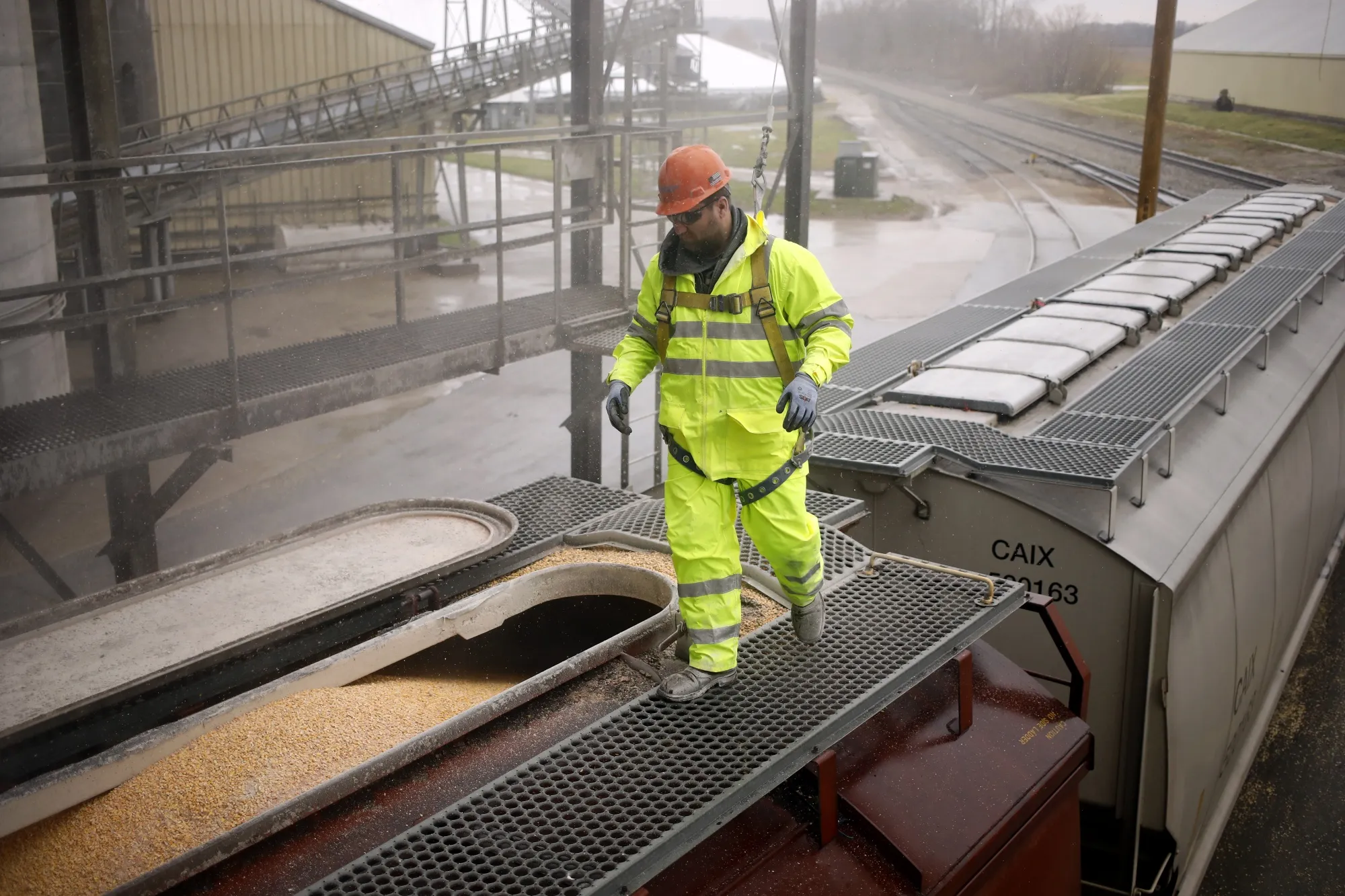 A worker prepares a railroad grain hopper car in Edinburgh, Indiana, U.S.
