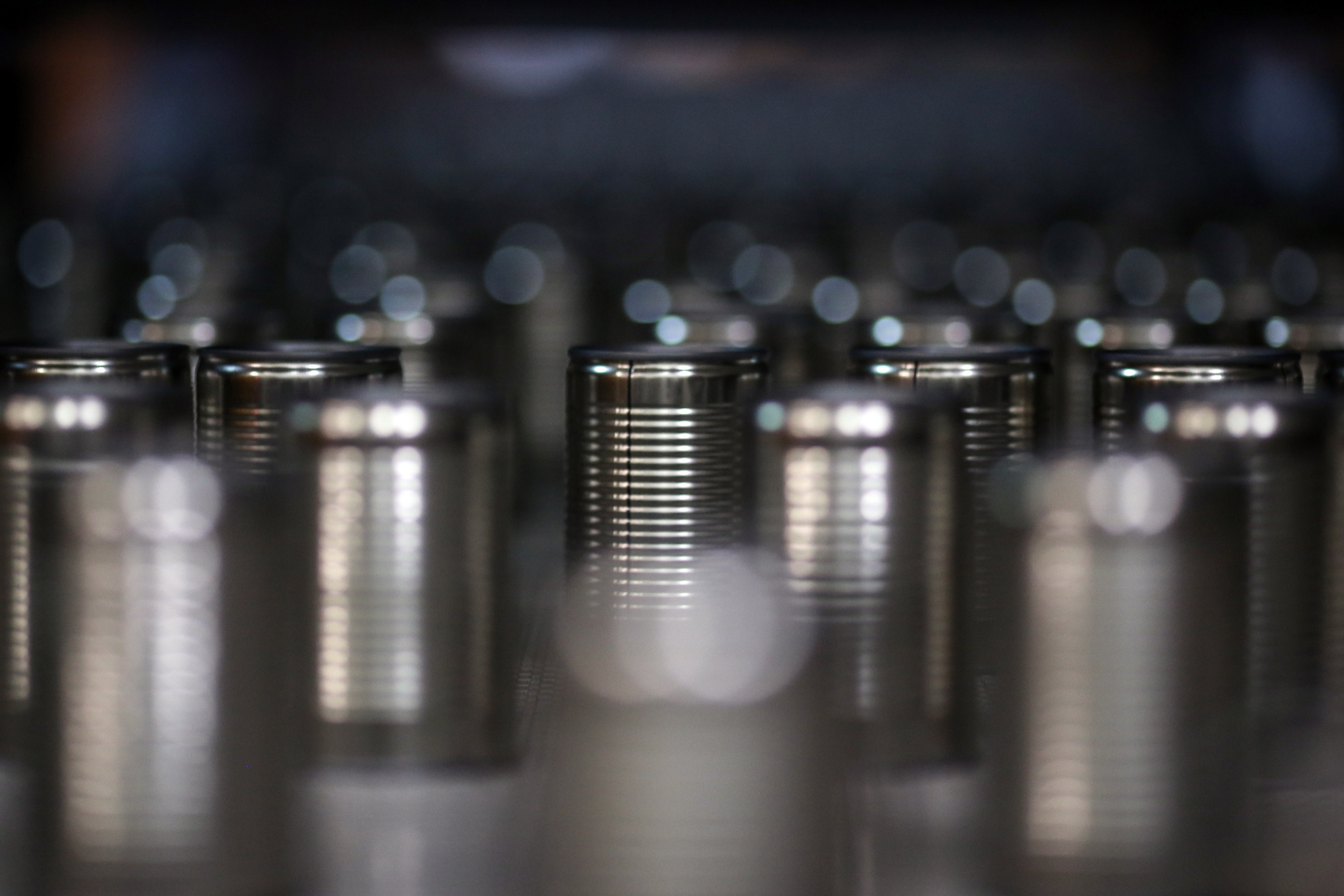 Tin cans&nbsp;move along a conveyor on a production line.