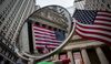 An American flag displayed outside of the New York Stock Exchange (NYSE) is reflected in a mirror in New York, U.S., on Tuesday, Sept. 6, 2016. Warnings embedded in strategist price targets and historically low U.S. stock volatility are doing nothing to dissuade hedge funds.