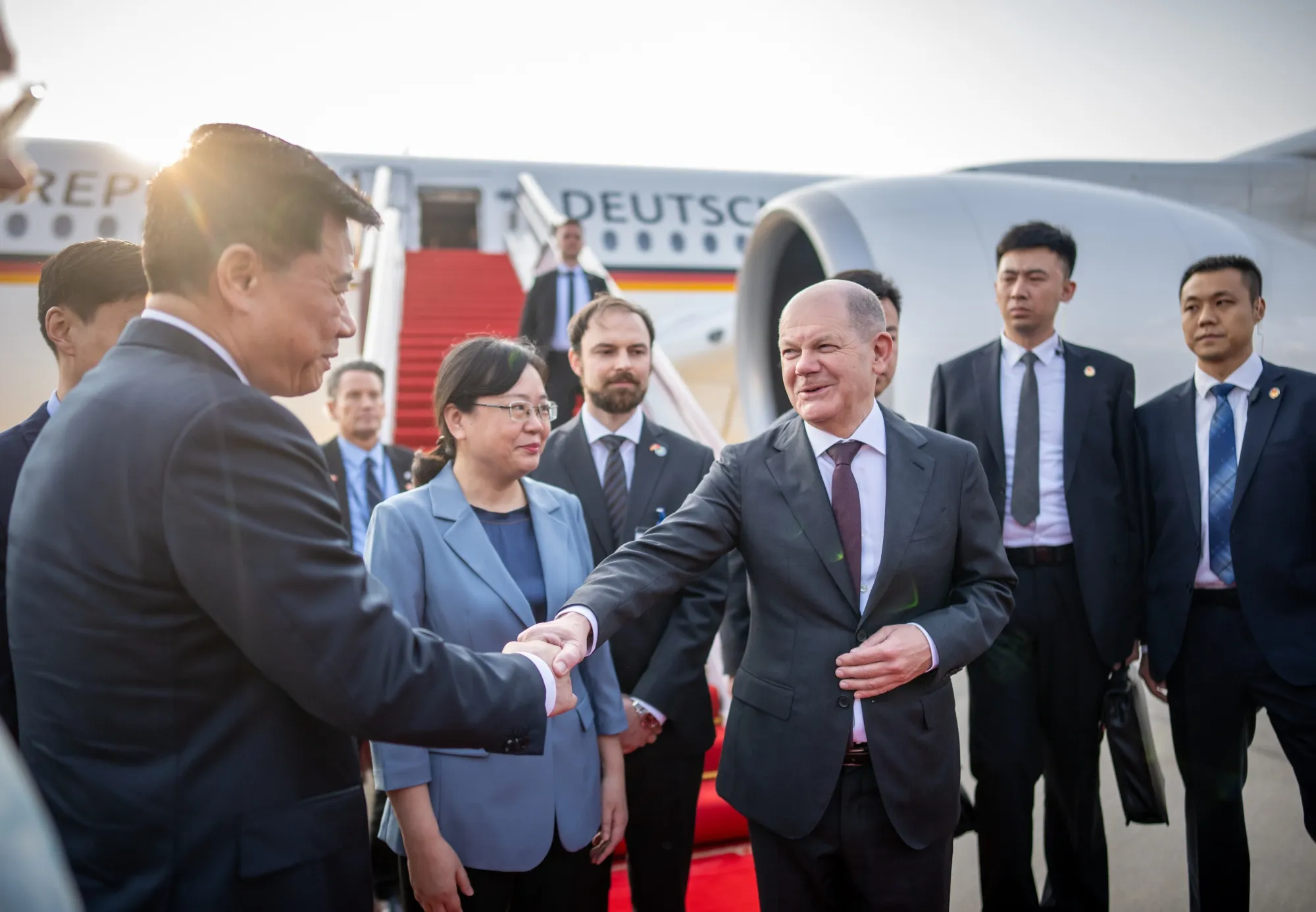 Olaf Scholz is greeted by Zhang Guozhi, Vice Mayor of Chongqing City, alongside Wu Ken, China's Ambassador to Germany at Chongqing Airport in China on April 14.