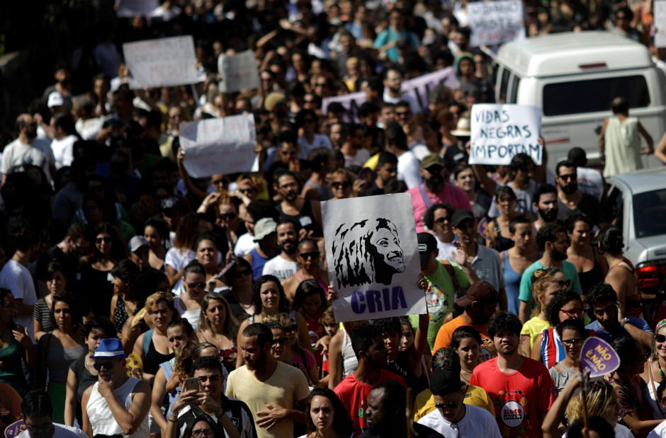 Protestors in Rio de Janeiro hold a picture of slain politician Marielle Franco.