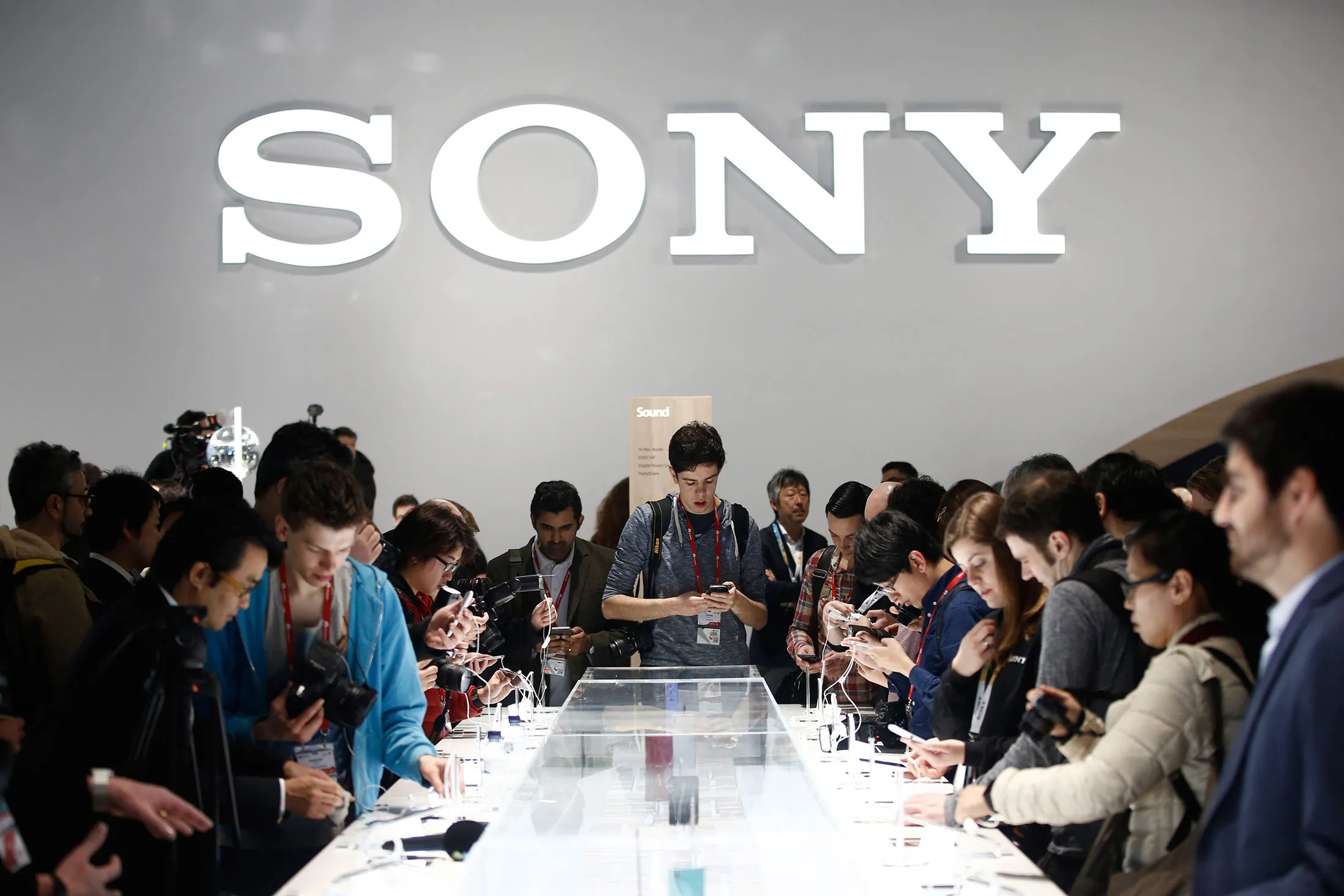 Visitors inspect Sony Xperia Z3, Z4 and M4 smartphones on display in the Sony Corp. pavilion at the Mobile World Congress in Barcelona, Spain, on Monday, March 2, 2015.
