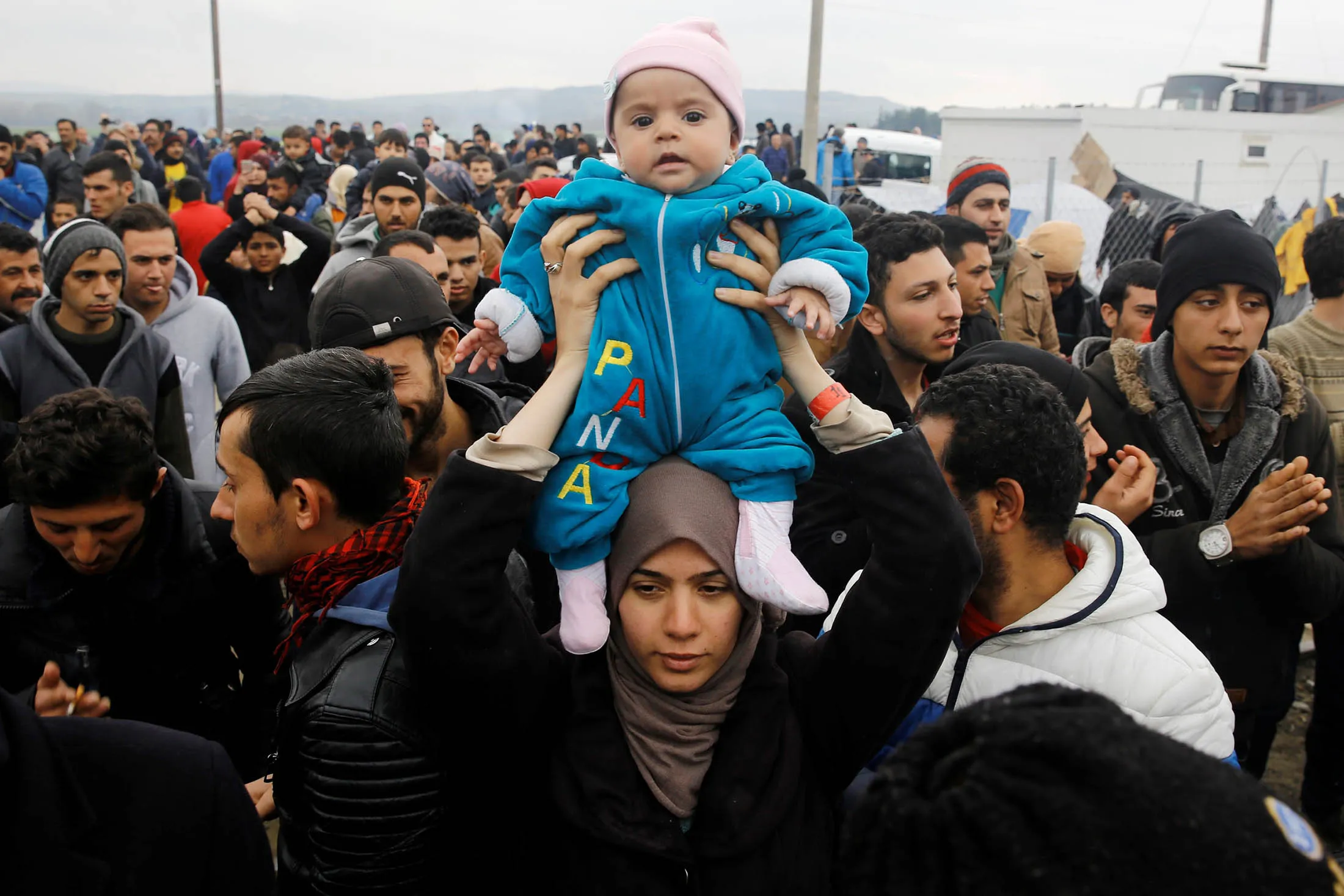 Refugees wait near railways along the Greece-Macedonia border in Kilkis, Greece, on Sunday.
