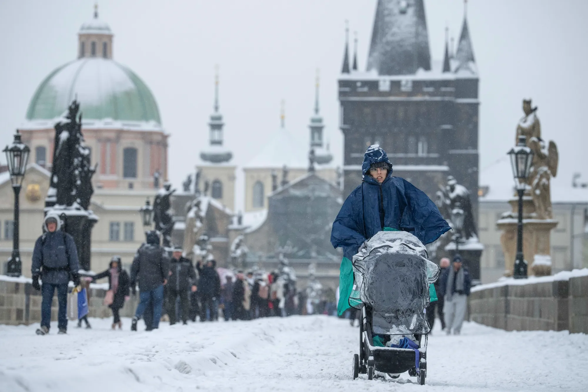 Visitors on Charles Bridge after snowfall in central Prague.