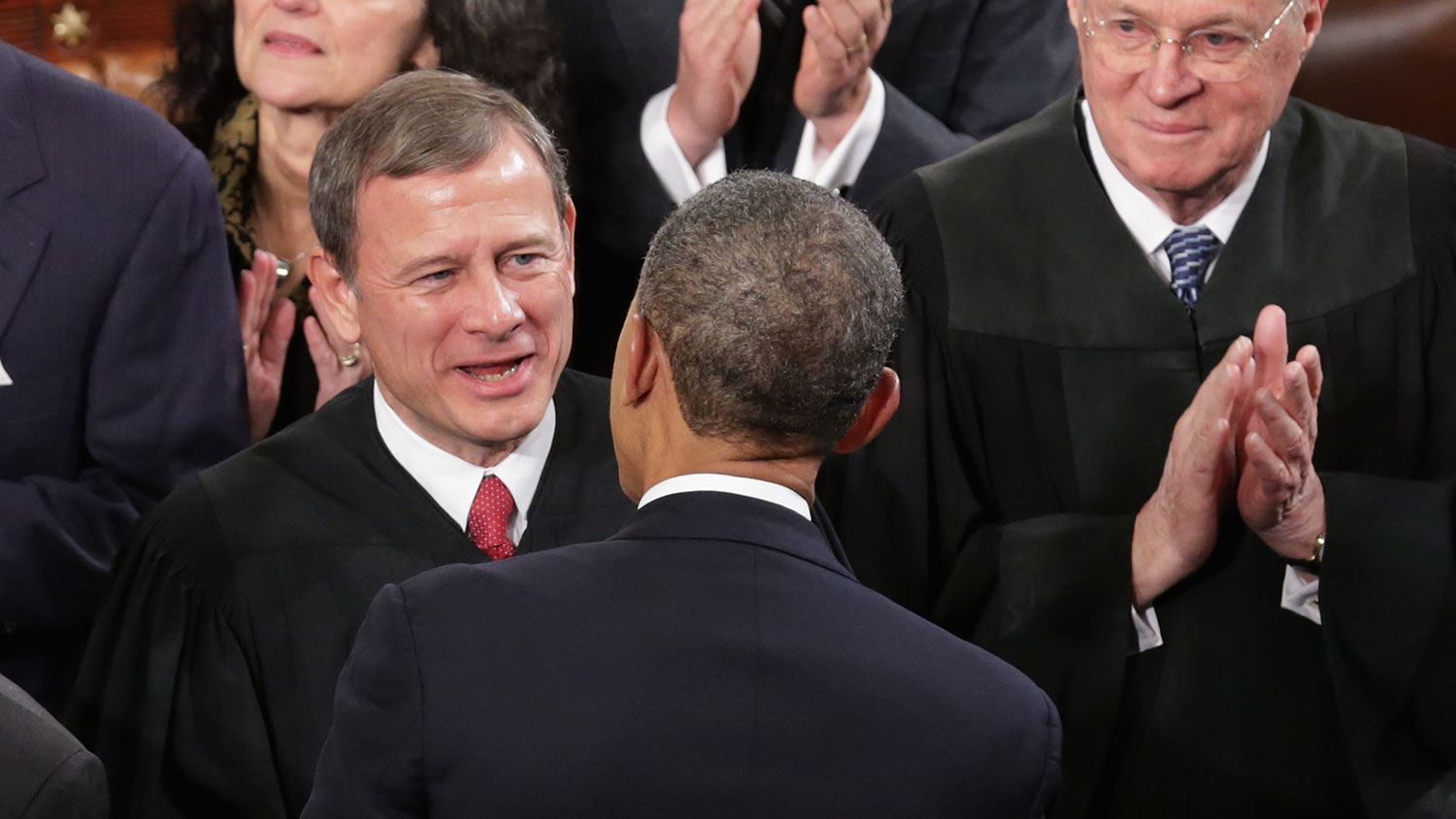 U.S. Supreme Court Chief Justice John Roberts (L) and Associate Justice Anthony Kennedy (R) talk with President Barack Obama before he delivers the State of the Union address to a joint session of Congress in the House Chamber at the U.S. Capitol on January 28, 2014 in Washington, DC.
