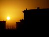 The sun sets beyond crude oil storage tanks at the Juaymah tank farm at Saudi Aramco's Ras Tanura oil refinery and oil terminal in Ras Tanura, Saudi Arabia.