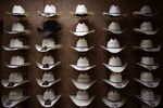 Stetson brand cowboy hats are displayed on a wall inside the showroom of the Hatco Inc. manufacturing facility in Garland, Texas,
