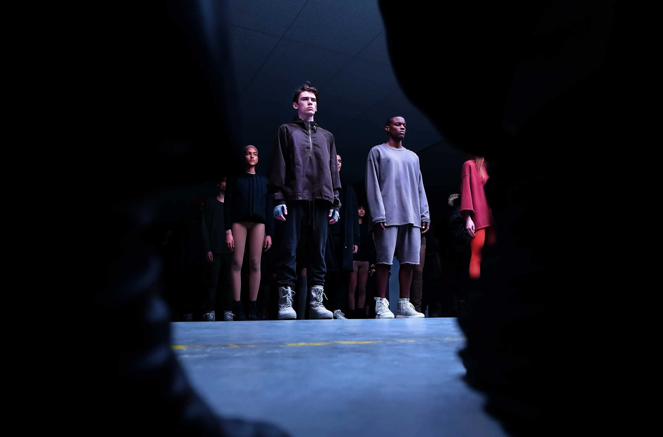 Models stand on the runway at the Adidas Originals x Kanye West YEEZY fashion show during New York Fashion Week in New York.
