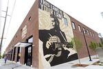 A mural of Woody Guthrie in Tulsa, Oklahoma. Since November 2018, Tulsa has been luring remote workers with the promise of $10,000 in cash. New research looks at the efficacy of place-based revitalization strategies.