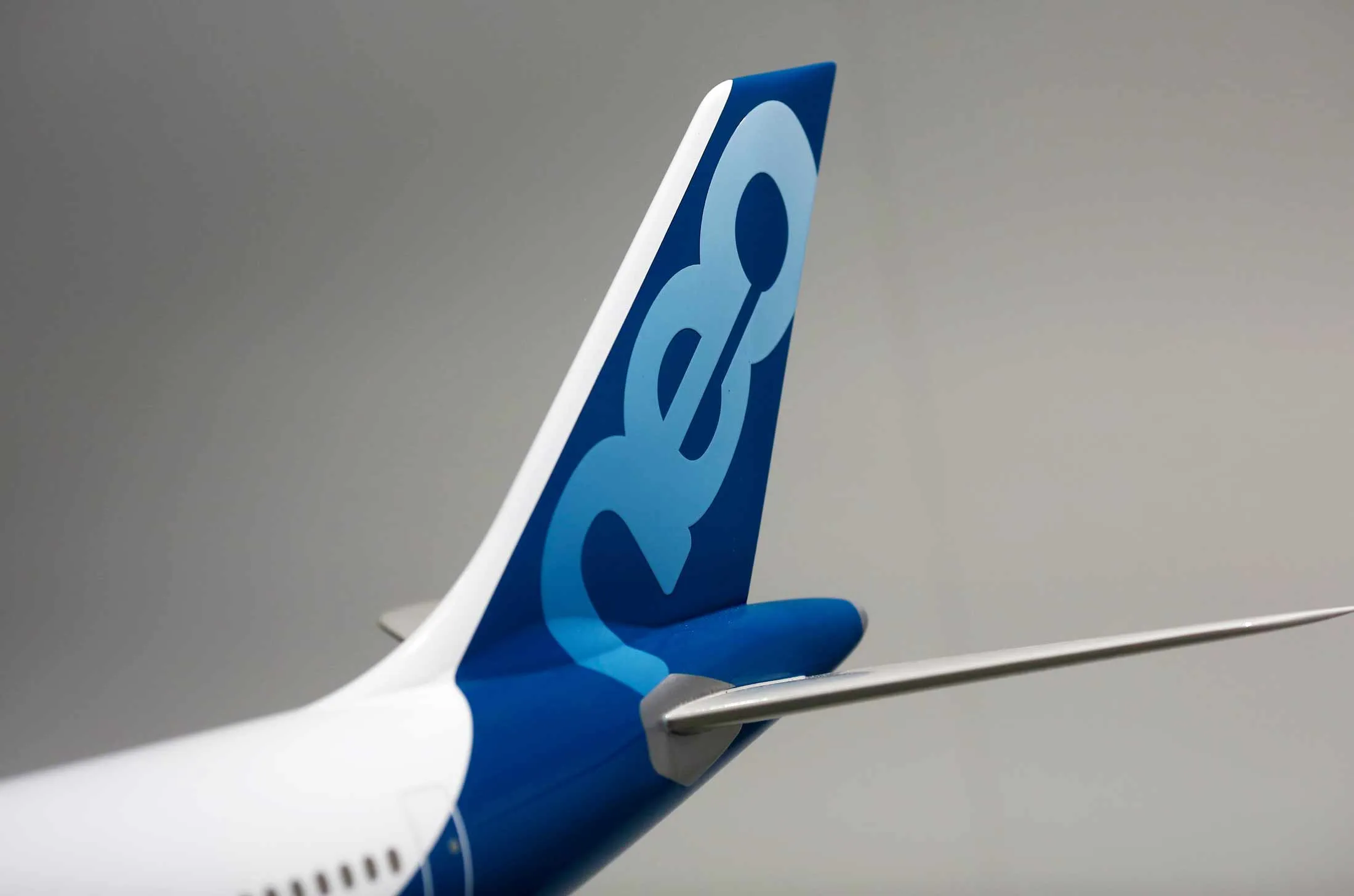 A neo logo sits on the tail fin of a model Airbus A330neo aircraft.
