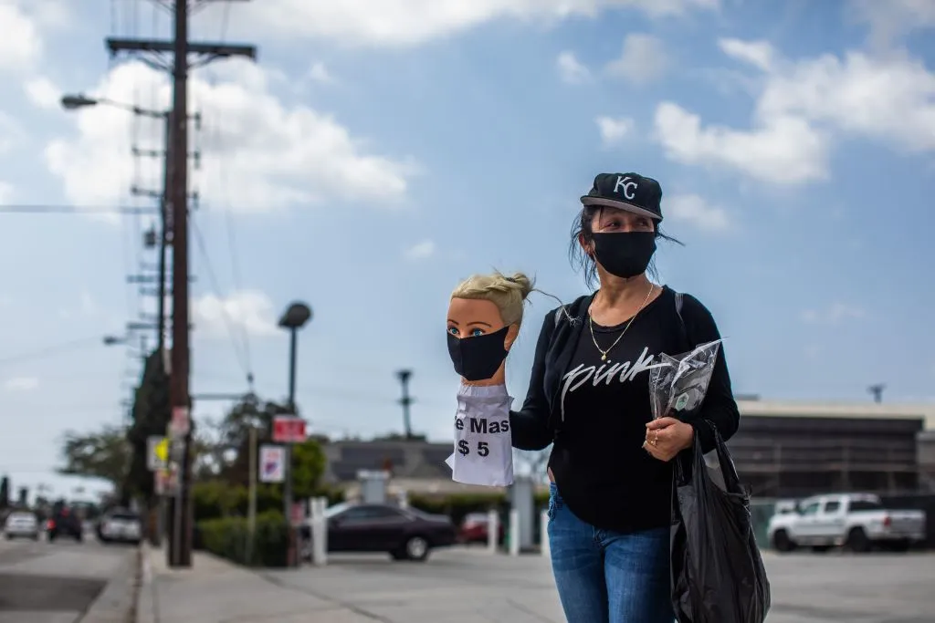 Dressmaker Flor Hernandez sells face masks on street in Los Angeles after losing her job to the coronavirus.