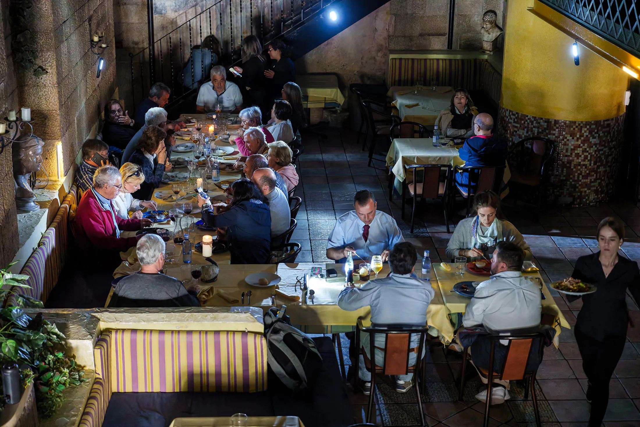 Customers dine by candlelight in a restaurant in Burgos, Spain, on April 28.