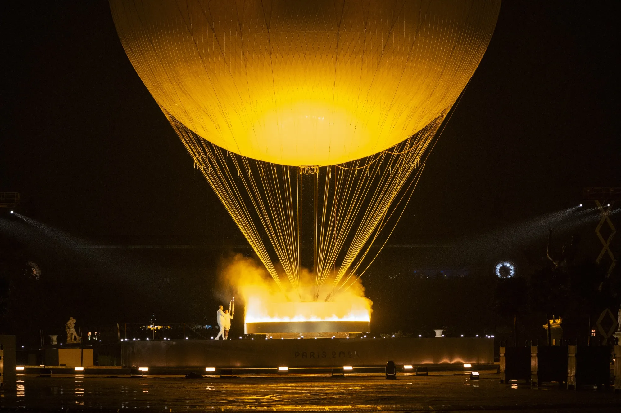 Teddy Riner, French Judo champion, holds a torch near the Olympic Cauldron during the opening ceremony of the Paris 2024 Olympic Games in Paris&nbsp;on&nbsp;July 26.