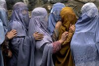 Women wait in line to receive food in Kabul in 2001.