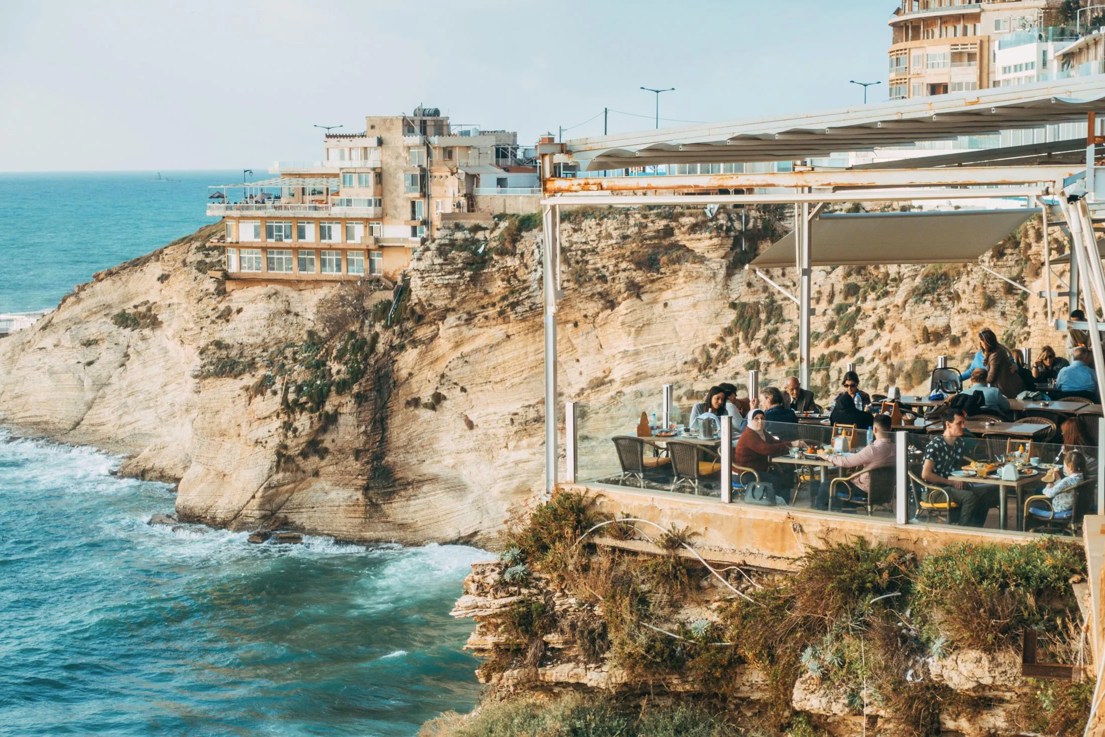 Diners at a café look out over the water near Raouche Rocks in Beirut, Lebanon