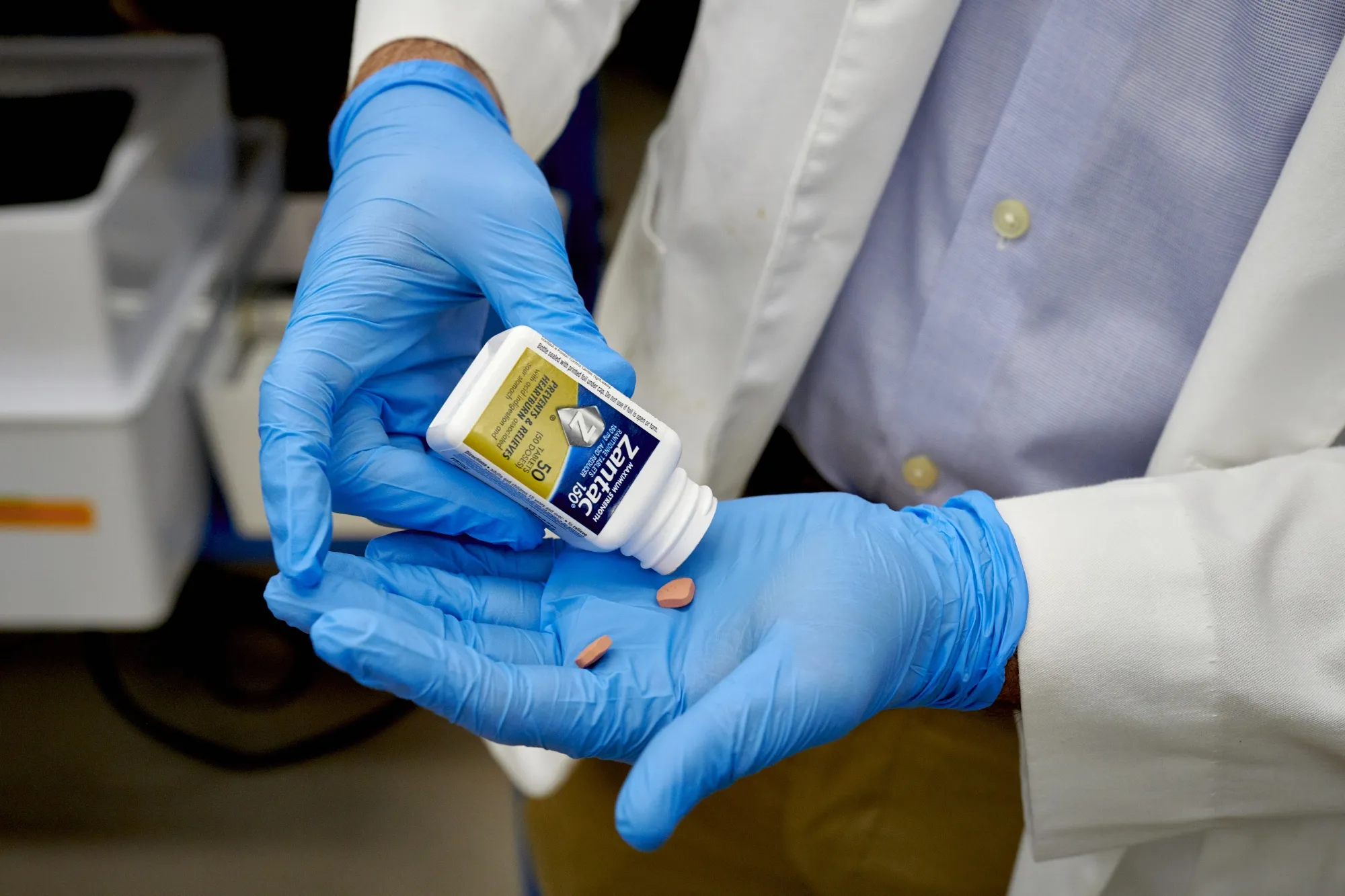 A researcher prepares to test a bottle of Zantac 150 at a lab in New Haven, Connecticut.