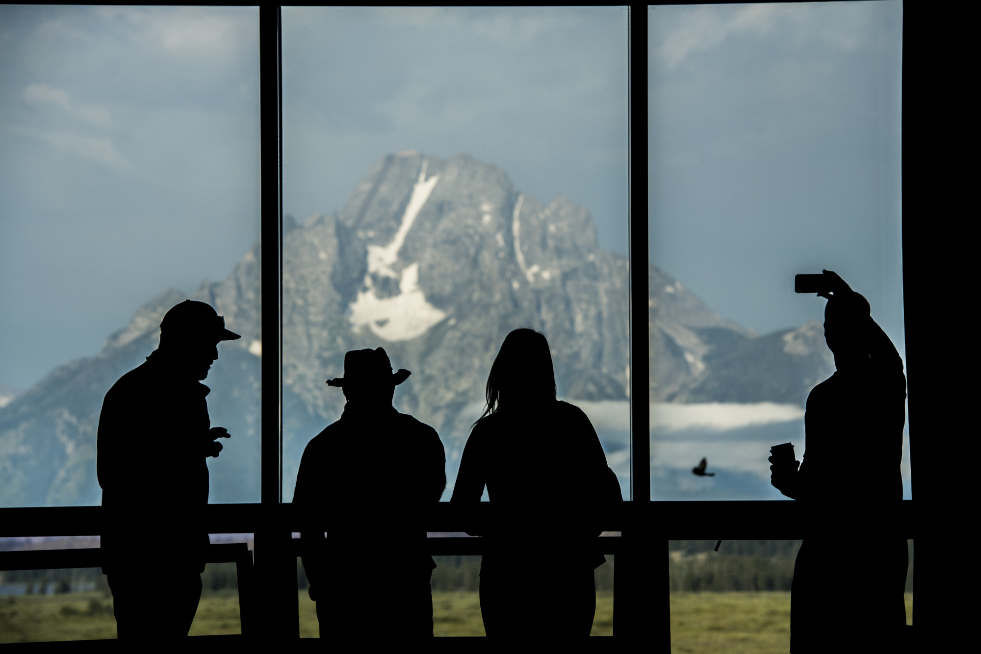 Tourists view&nbsp;the Grand Teton mountain range outside of the Jackson Lake Lodge in Moran, Wyoming.