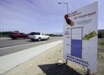 Cars drives by a sign encouraging residents to save water in Rancho Santa Margarita, California.