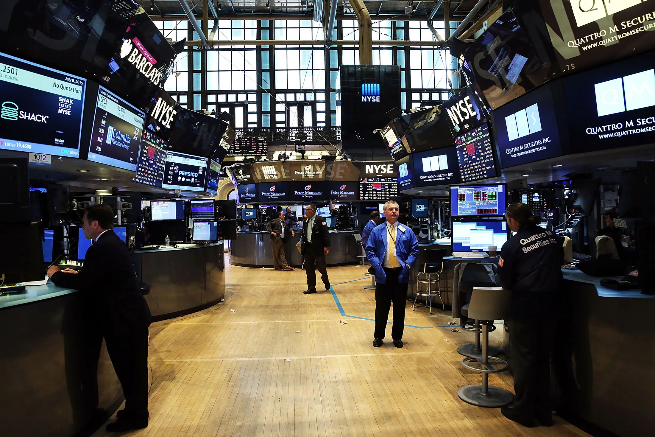 Traders stand on a nearly empty trading floor at the New York Stock Exchange after trading was halted due to a 'technical glitch' on July 8, 2015 in New York City.
